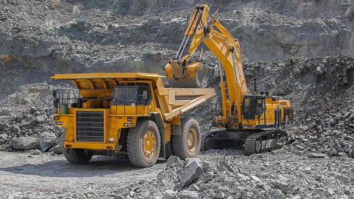 Open pit mining equipment loading haul trucks